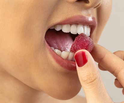 Person enjoying a Make My Day gummy supplement