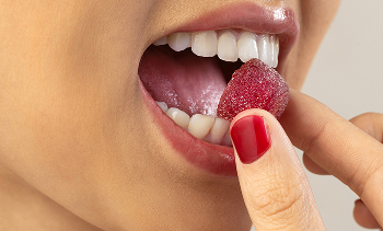 Person enjoying a Make My Day gummy supplement